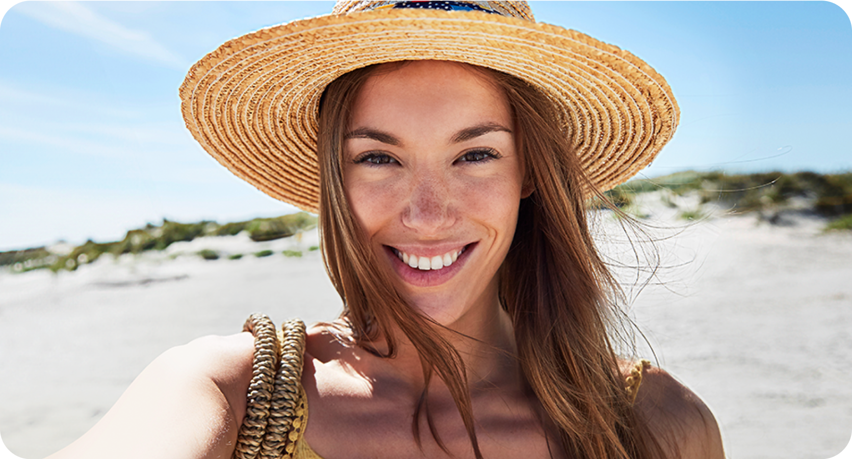 a woman wear hat and taking selfie